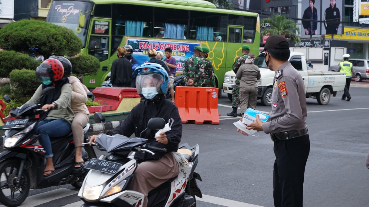 Kabid Humas Polda Lampung bersama TNI dan SMSI Bagikan 3000 Masker kepada Pengguna Jalan